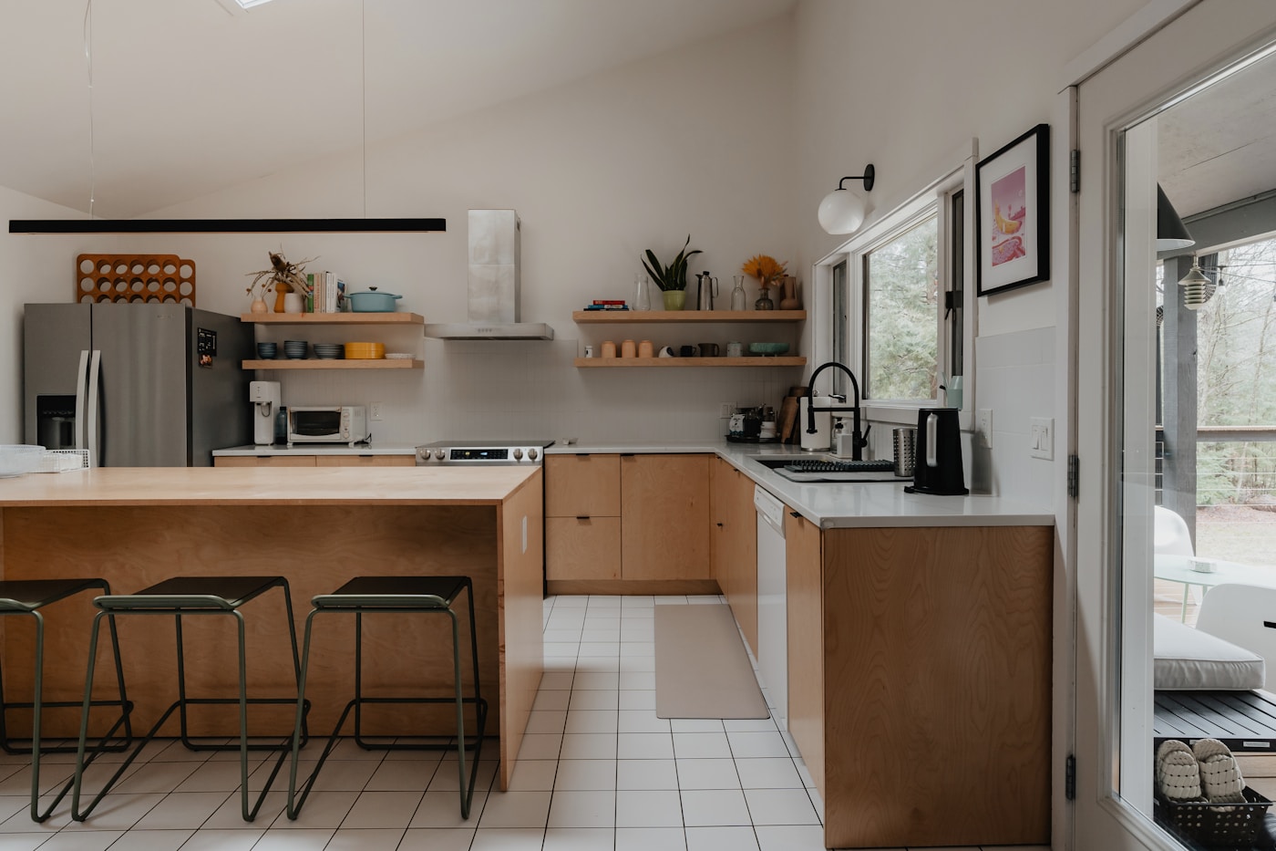 Residential kitchen with an island, appliances, and natural light